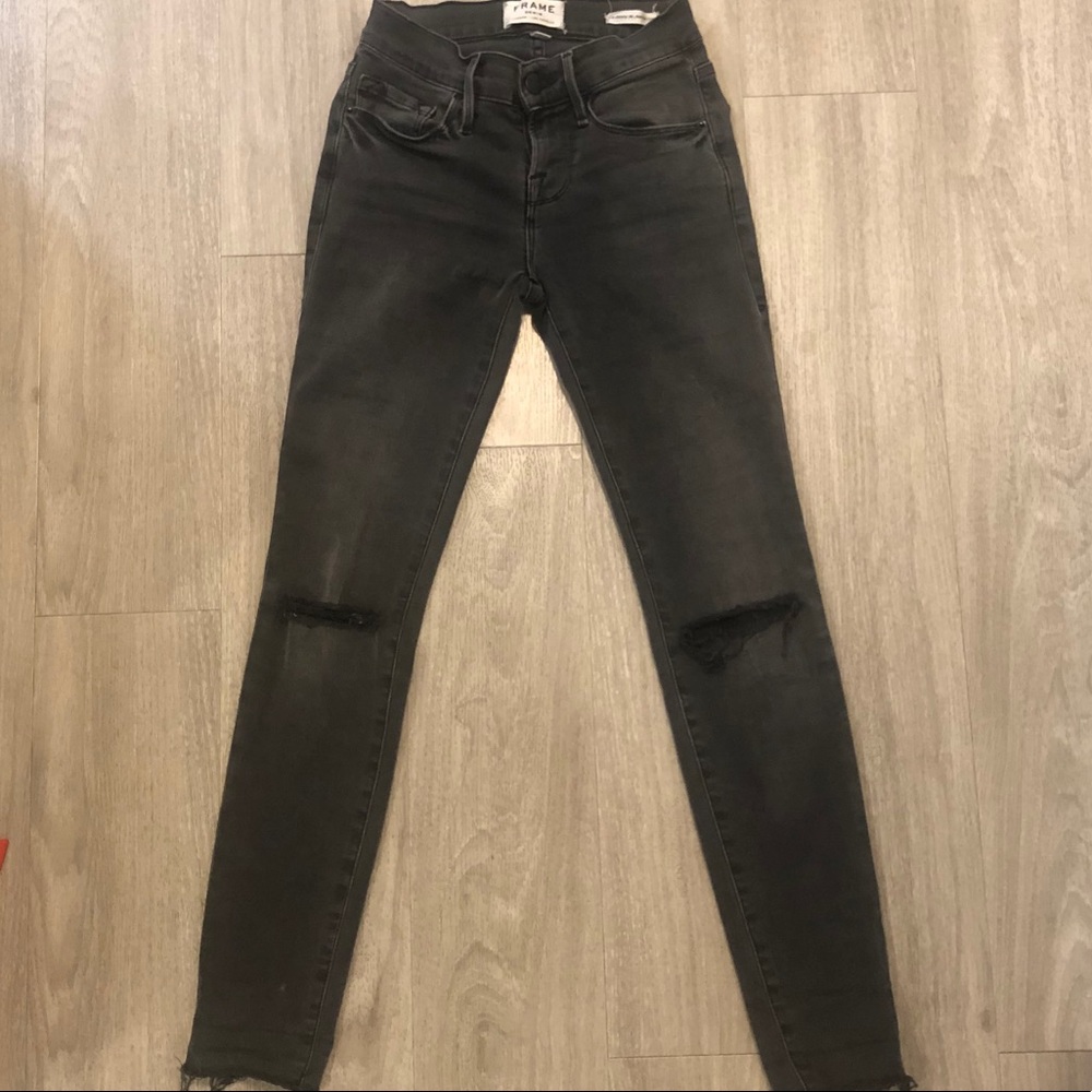 Frame Denim’s black skinny jeans with knee rips